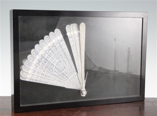 A Chinese export ivory brise fan, c.1800, length 20.5cm, framed and glazed